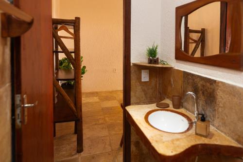 a bathroom with a sink and a mirror at Kitenest in Itarema