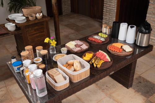 a table with different types of food on it at Kitenest in Itarema