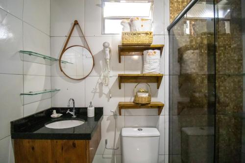 a bathroom with a toilet and a sink and a shower at Pousada da Leide in Fernando de Noronha