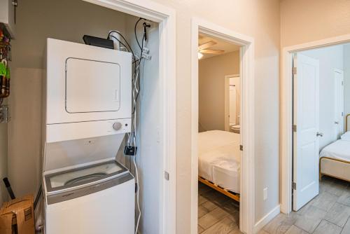 a room with a refrigerator and a room with a bed at Serene 2BR Home with Premium Beds in Glendale