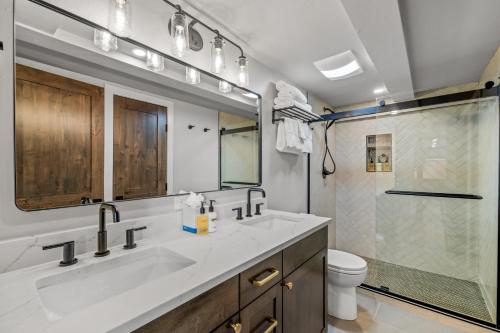 a bathroom with two sinks and a shower at Bear Claw 402 - Premier Ski-in Ski-out & Winter Shuttle! Renovated 2025! in Steamboat Springs
