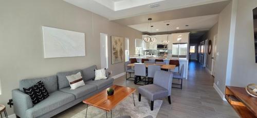 a living room with a couch and a dining room at Lux Modern 3BR - 2BA Duplex Brand New Furnished in Brownsville