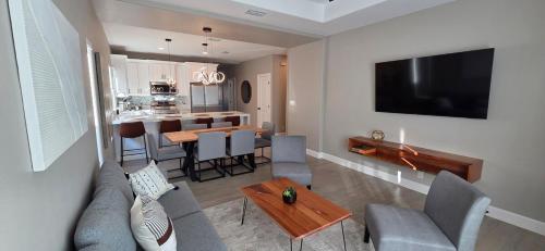 a living room with a couch and a table at Lux Modern 3BR - 2BA Duplex Brand New Furnished in Brownsville