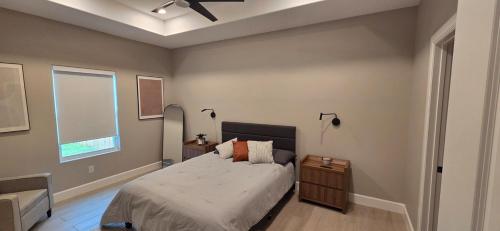 a bedroom with a bed and a ceiling fan at Lux Modern 3BR - 2BA Duplex Brand New Furnished in Brownsville