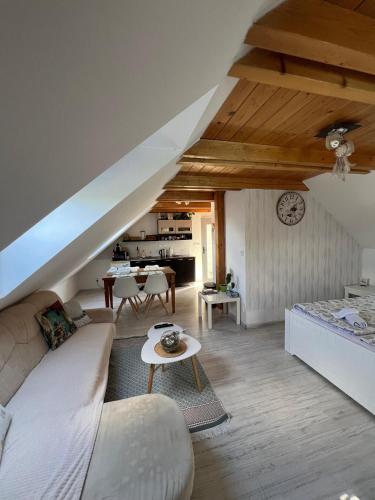 a living room with a couch and a table at Apartmán Doubravice - s výhledem do zahrady in Hrubá Skála