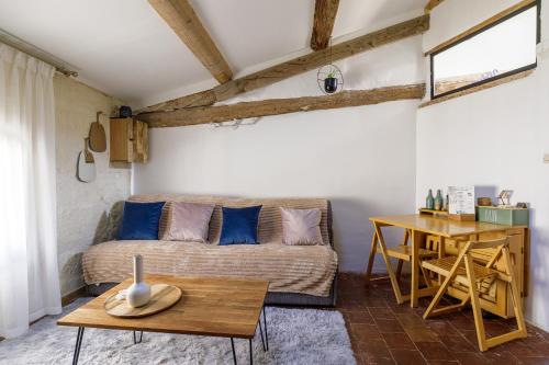 a living room with a couch and a table at L'escalier gaucher in Lambesc