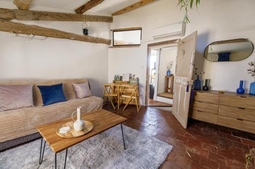 a living room with a couch and a table at L'escalier gaucher in Lambesc