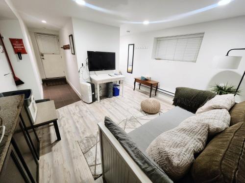 a living room with a couch and a television at Small Private Studio at Kitsilano Beach in Vancouver