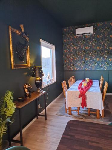 a dining room with a table and a window at Gustavsbo in Ljungbyhed