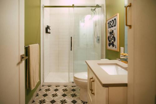 a bathroom with a shower and a toilet and a sink at Historic Charming 2BR Apartment DT Halifax in Halifax