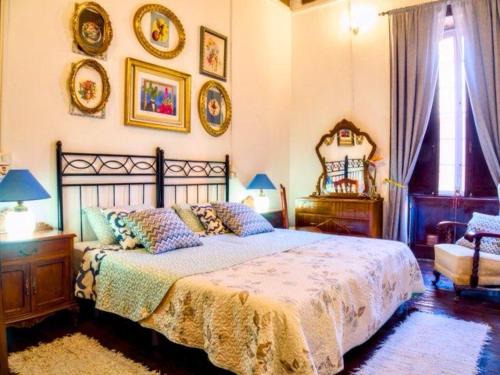 a bedroom with a bed and some pictures on the wall at Aloe Apartament 2 plus 1 gratis w Casa Verde de Guía in Santa Maria de Guia de Gran Canaria