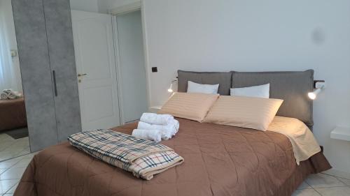 a bedroom with a large bed with a pillow on it at Oxi in Modena