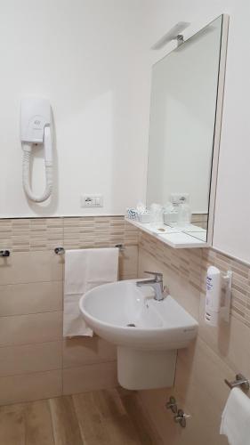 a bathroom with a sink and a mirror at Hotel Villa Etrusca in Marina di Campo