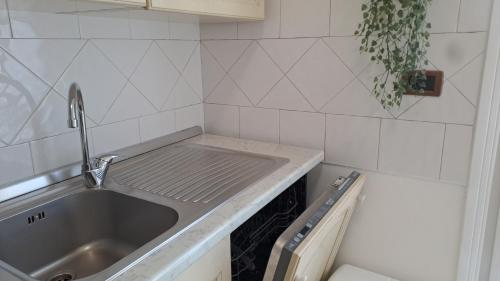 a kitchen with a sink and a counter top at Oxi in Modena