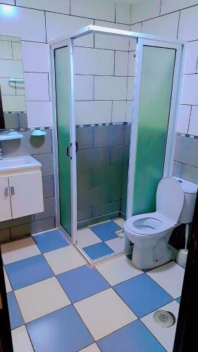 a bathroom with a toilet and a glass shower at le riffe in Nador