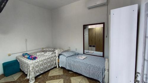 Ein Bett oder Betten in einem Zimmer der Unterkunft Pousada da Dinda - Casa Familiar