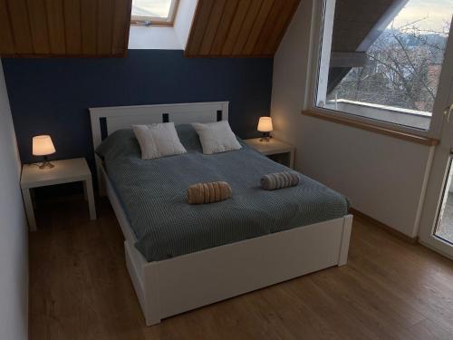 a bedroom with a bed with two pillows on it at Stay with a View in Gdynia