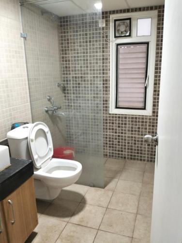 a bathroom with a toilet and a shower at Elegant Stay at Bangalore International Airport in Bangalore