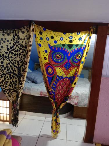 a room with a bed with a curtain on it at Hostel & Cia Itanhaém in Itanhaém