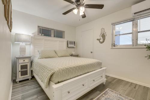 a bedroom with a bed and a ceiling fan at Walk to Shops and Dining Downtown Stuart Home! in Stuart