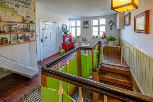 a room with a staircase with a green railing at Alandblick Gasthaus in Wanzer