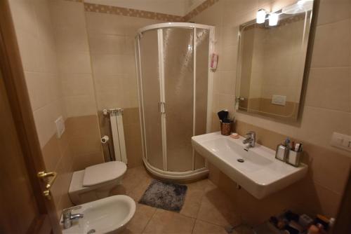 a bathroom with a shower and a sink and a toilet at Nenni House in Sassari
