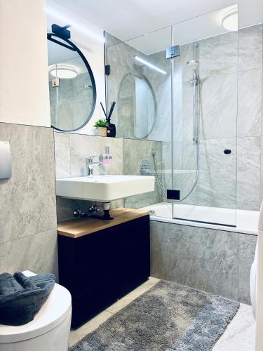 a bathroom with a sink and a shower at LYMA Suites - Apartment G2 in Immenstadt im Allgäu