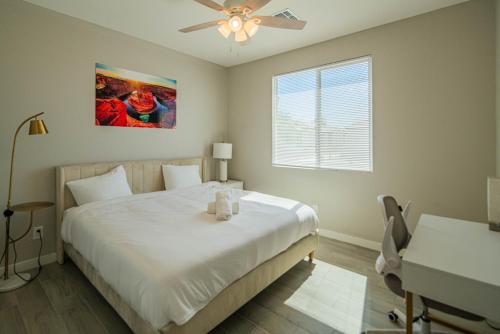 a bedroom with a bed and a ceiling fan at Serene 2BR Home with Premium Beds in Glendale