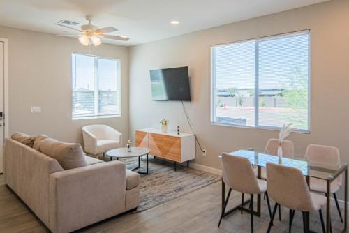 a living room with a couch and a table at Serene 2BR Home with Premium Beds in Glendale