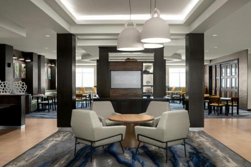 a lobby with chairs and a table and a bar at Fairfield Inn & Suites Riverside Corona/Norco in Norco