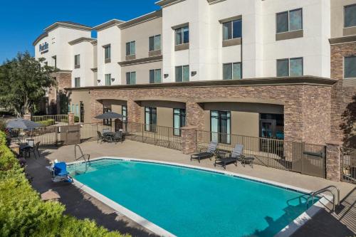 an image of a swimming pool in front of a building at Fairfield Inn & Suites Riverside Corona/Norco in Norco