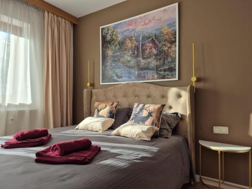 a bedroom with a bed with two pillows on it at OTILIA apartment in Zell am See