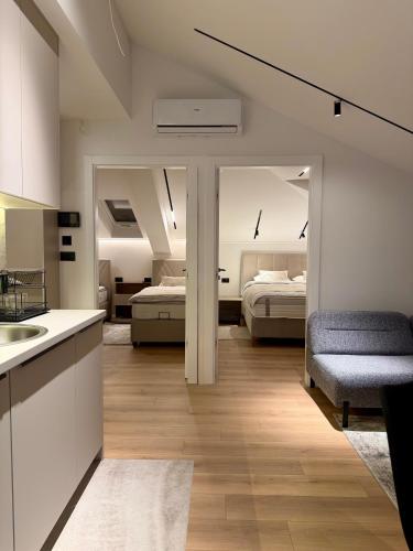 a kitchen and living room with two beds and a sink at Residence 33 in Sarajevo