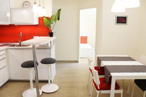 a kitchen with a table and chairs and a dining room at City Centre Apartment in Budapest