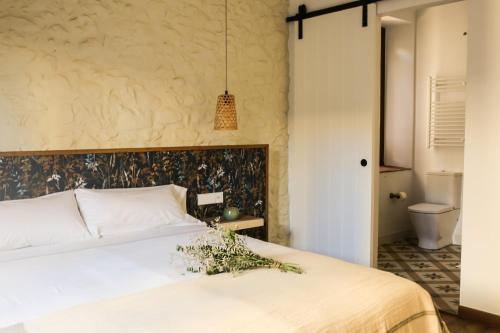 En eller flere senge i et værelse på UMA Rural Boutique