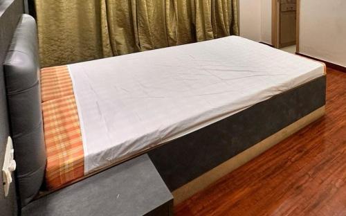 a bed in a hospital room with a mattress at Siddhi's Inn in Prayagraj