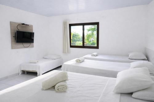 En eller flere senge i et værelse på Pousada Solar da Praia