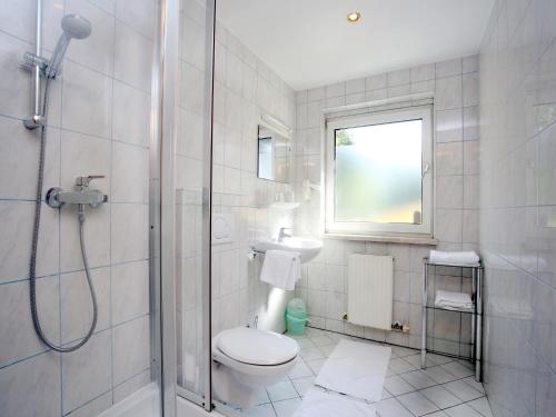 a bathroom with a shower and a toilet and a sink at Gasthof Rothmayr in Linz