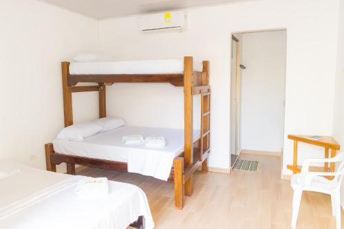 a room with two bunk beds and a table at ZABDI COVEÑAS in Coveñas