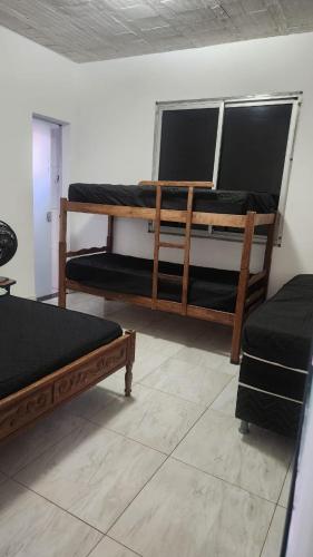 a room with two bunk beds in a room at Sitiolosbragas in Caetanópolis