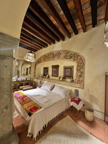 a bedroom with a large bed in a room at Atelier Oaxaca in Oaxaca City