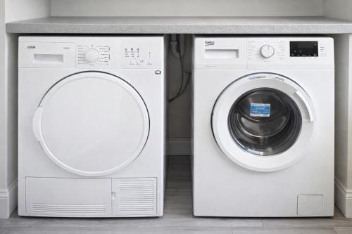 a white washer and dryer in a room at The Stadium Rooms Elegant and Comfy Stay in London