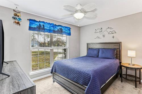 a bedroom with a bed and a ceiling fan at 1973 Salamanca St in Navarre