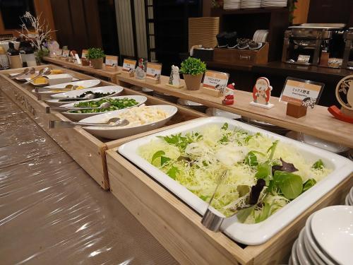 a buffet line with plates of food on display at Hotel Route-Inn Saga Ekimae in Saga
