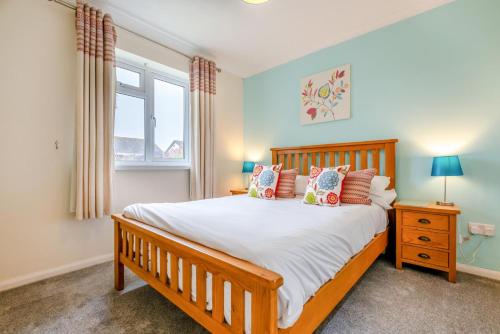 a bedroom with a large bed and a window at 3 Bed in St. Merryn oc-p00114 in Saint Merryn