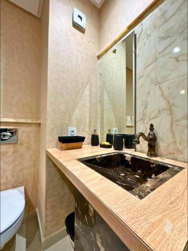 a bathroom with a sink and a toilet at Noble Suite Luxury in Tangier