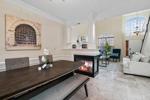 ein Wohnzimmer mit Tisch und Kamin in der Unterkunft Cozy 4B 2 5B University Home King Beds Jacuzzi in Charlotte