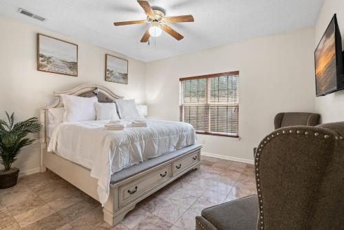 a bedroom with a bed and a ceiling fan at Cozy 4B 2 5B University Home King Beds Jacuzzi in Charlotte
