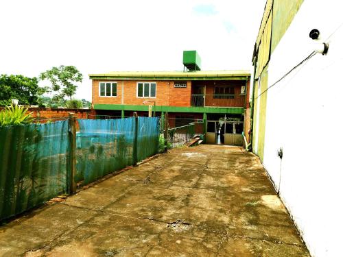 an empty alley with a building and a fence at Posada Familiar ELDORADO in Eldorado