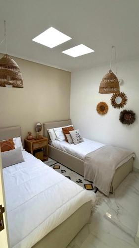 a bedroom with two beds and two lamps at Praia da Barra Sweet Home in Gafanha da Nazaré